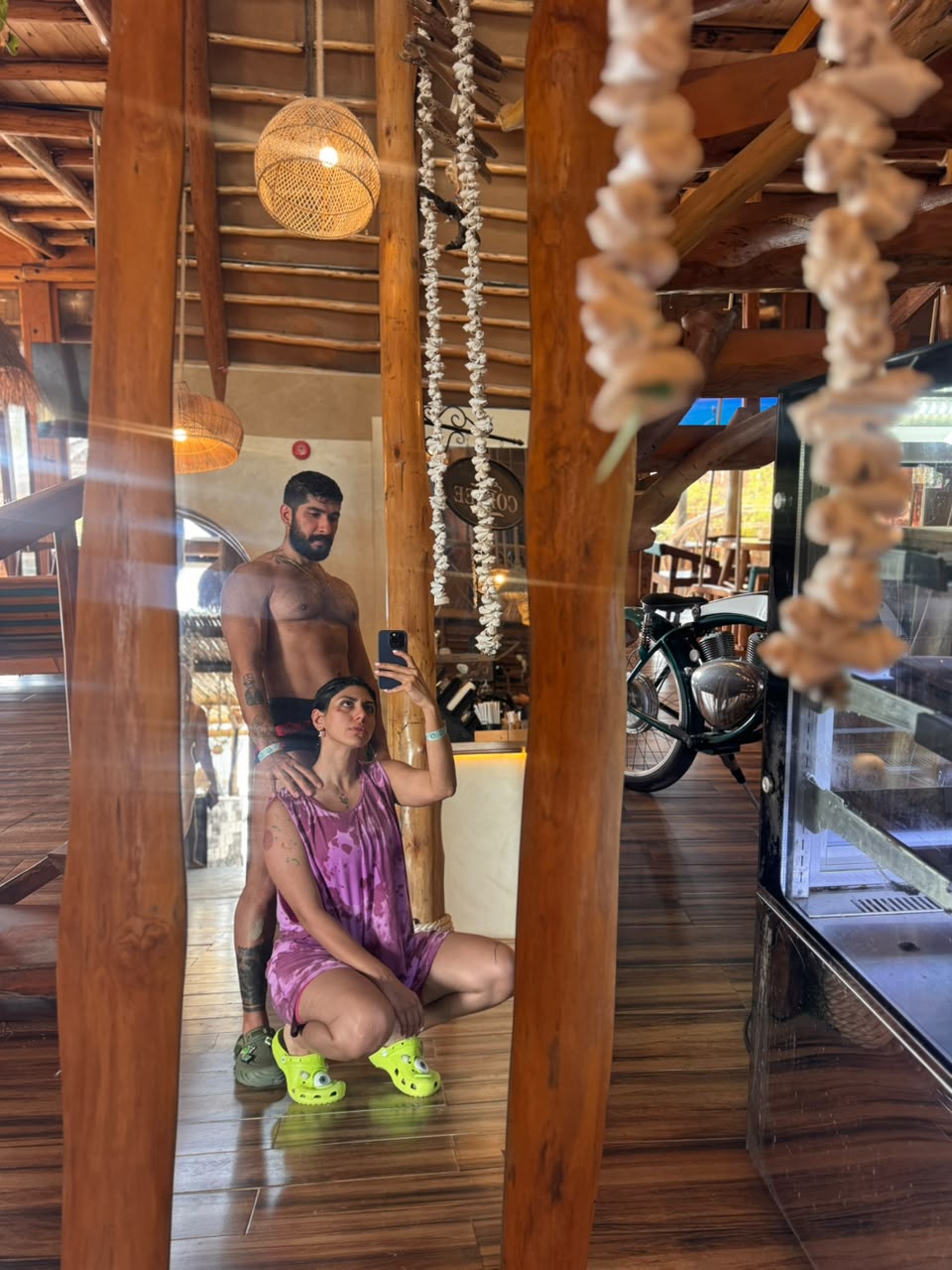 Sadaf and Arash mirror photo in a wooden beach café