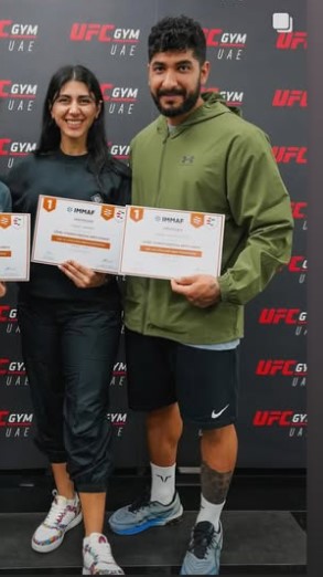 Sadaf Aghaei and Arash Alikhaniyan with IMMAF coaching certificates