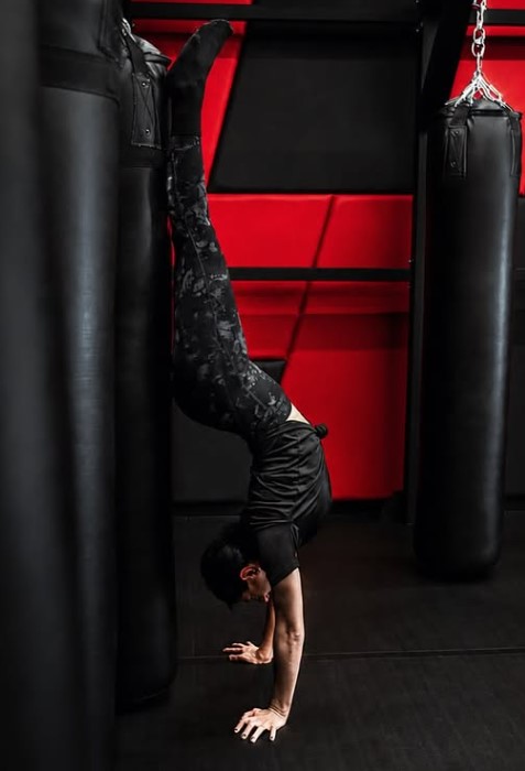 Sadaf Aghaei holding a handstand in the studio