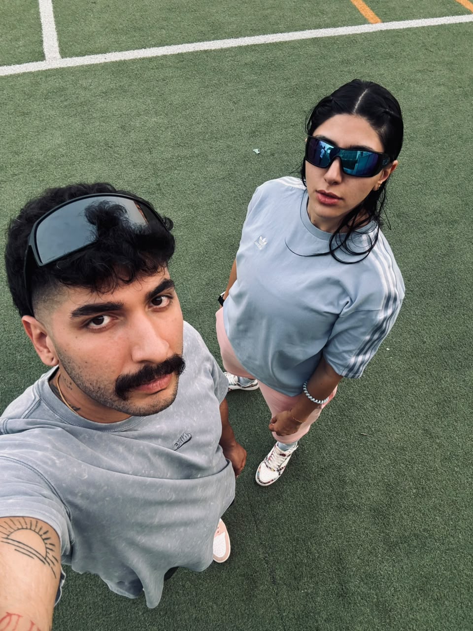 Sadaf and Arash selfie on a sports field
